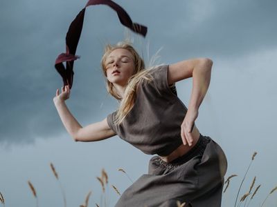 A dynamic shot of a person performing a fluid bodyweight movement.